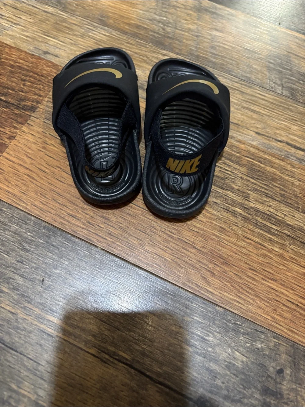 Nike Kids Black Slide Sandals with Gold Swoosh Accent
